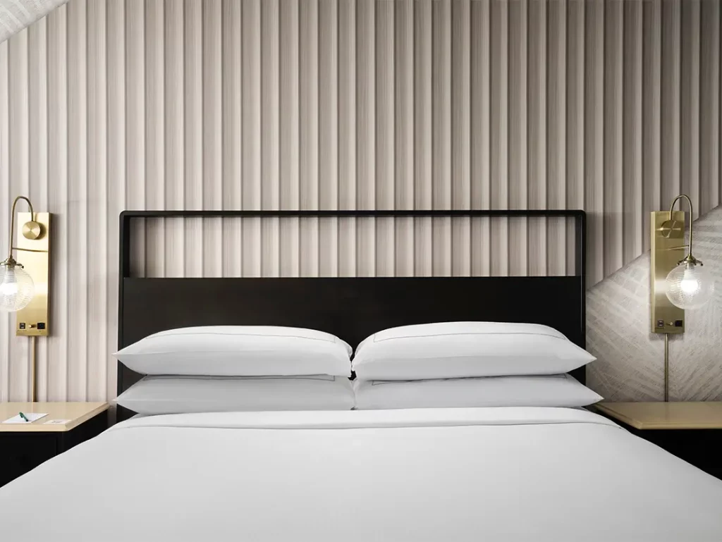 close up of king bed made up at hotel fera