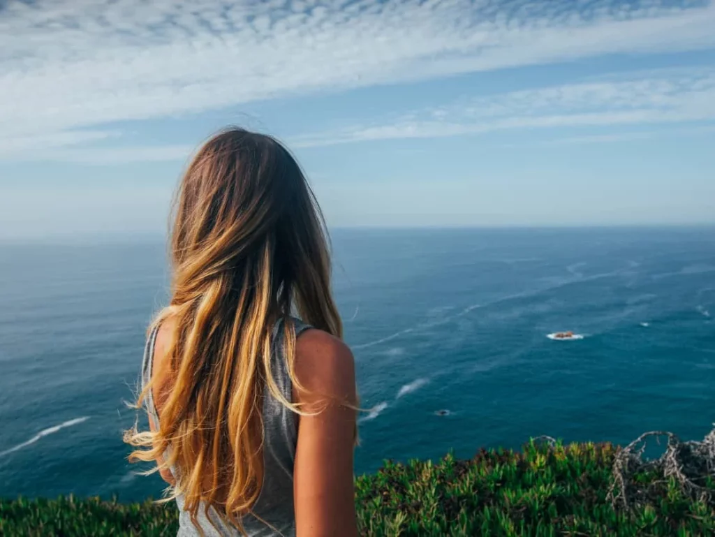 back view of woman looking at the ocean