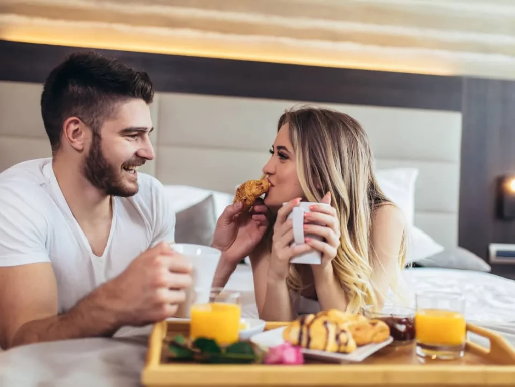 couple enjoying breakfast in bed