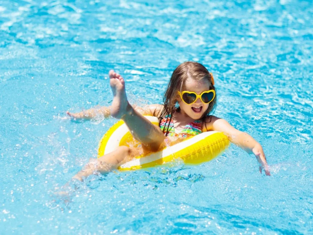 a child floating in a yellow pool floatie